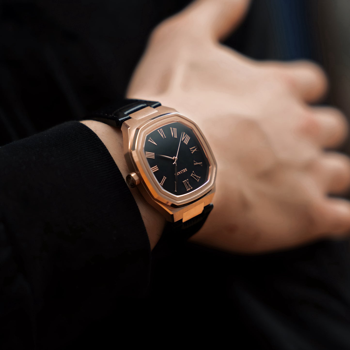 Close-up of Belvans Heritage rose gold watch on wrist with Musou Black dial
